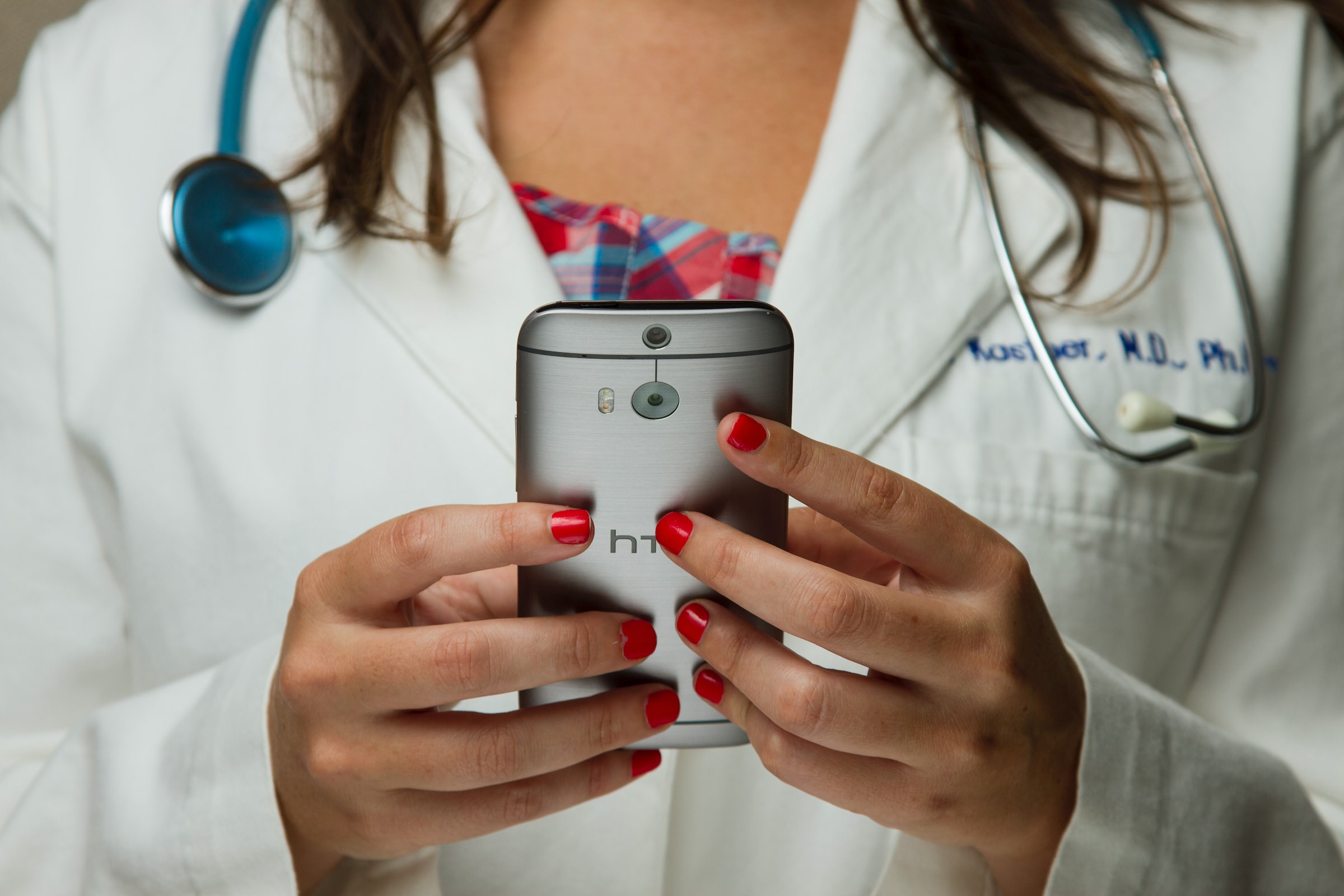 Female doctor using an htc phone